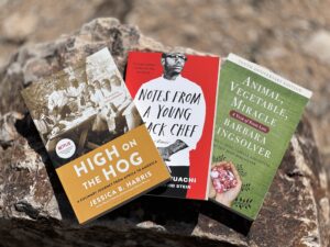 Tucson Tome Gnomes image of three books they're hiding at the farmers market